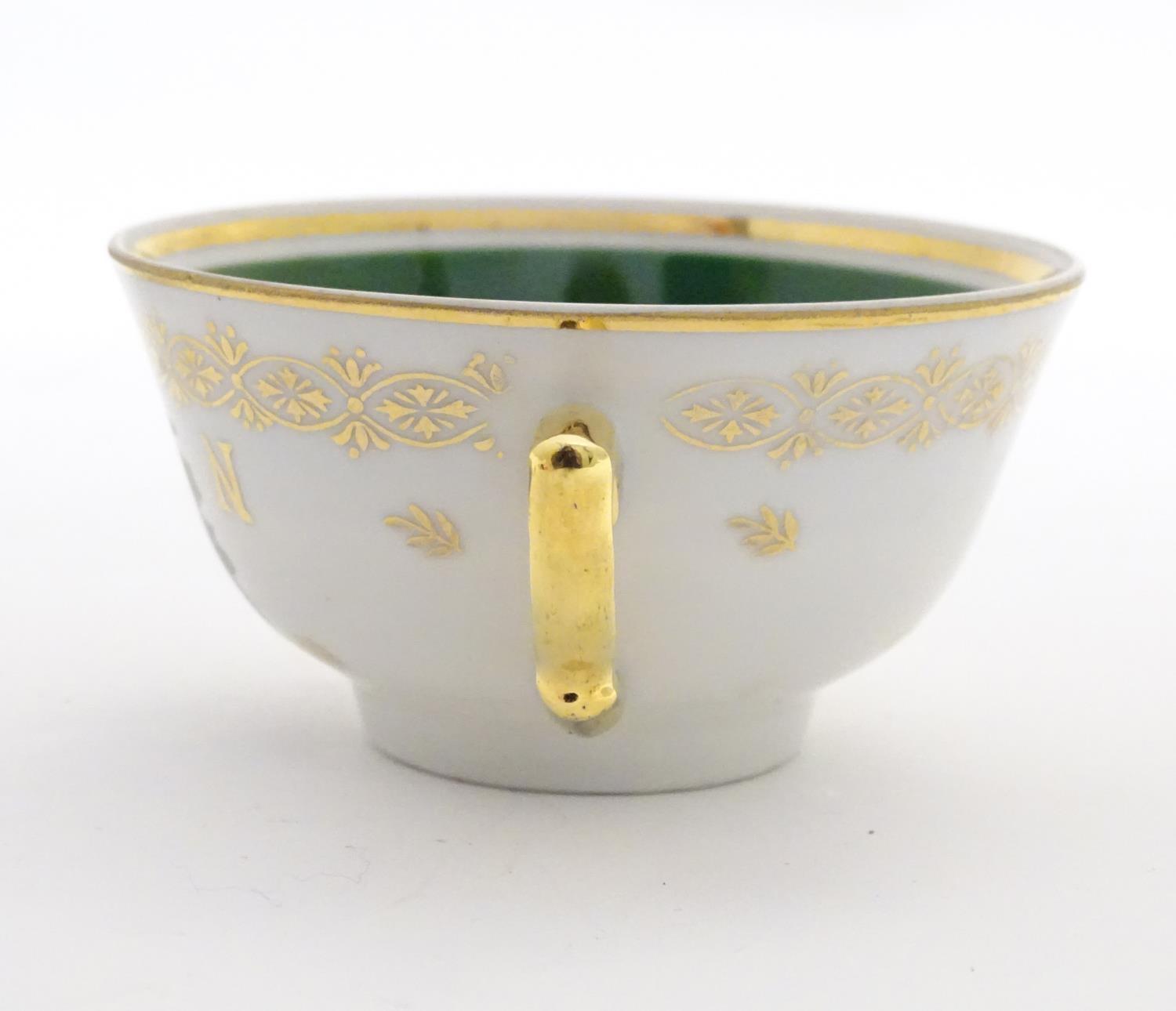 A French tea cup and saucer depicting Emperor Napoleon with green and gilt highlights. Porcelaine de - Image 4 of 10