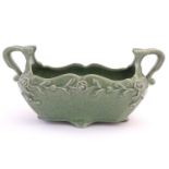 A celadon style plant holder / flower trough with a crackle glaze and floral and foliate detail.