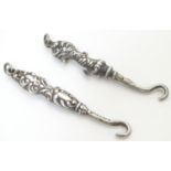 Two silver glove / small button hooks, one hallmarked Birmingham 1908 maker Adie Lovekin Ltt. Approx