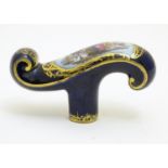 A Continental ceramic cane handle with a cobalt blue ground and hand painted winter scene