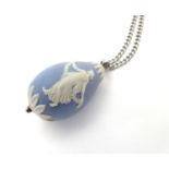 A blue egg formed pendant with Wedgwood blue Jasperware decoration approx. 1 1/2" long Please Note -