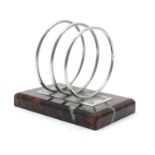 An Art Deco letter rack with chrome ring divisions on a serpentine base. Approx. 3 1/2" high