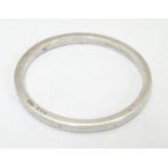 A silver bangle of plain circular form, hallmarked Birmingham 1912 maker Adie Lovekin Ltd. Please