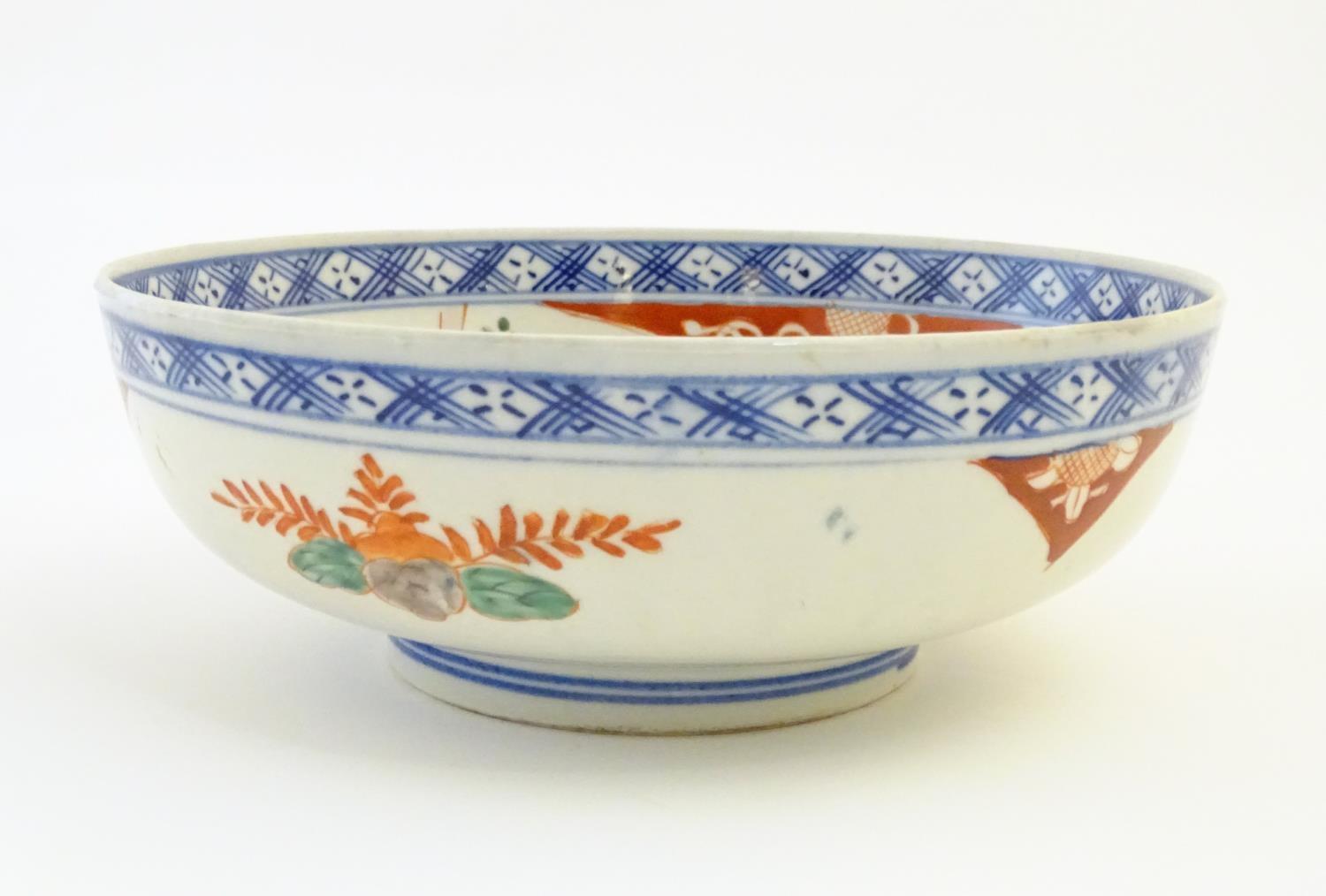 A Japanese bowl with hand painted decoration depicting a landscape scene with flowers, a crane - Image 2 of 7