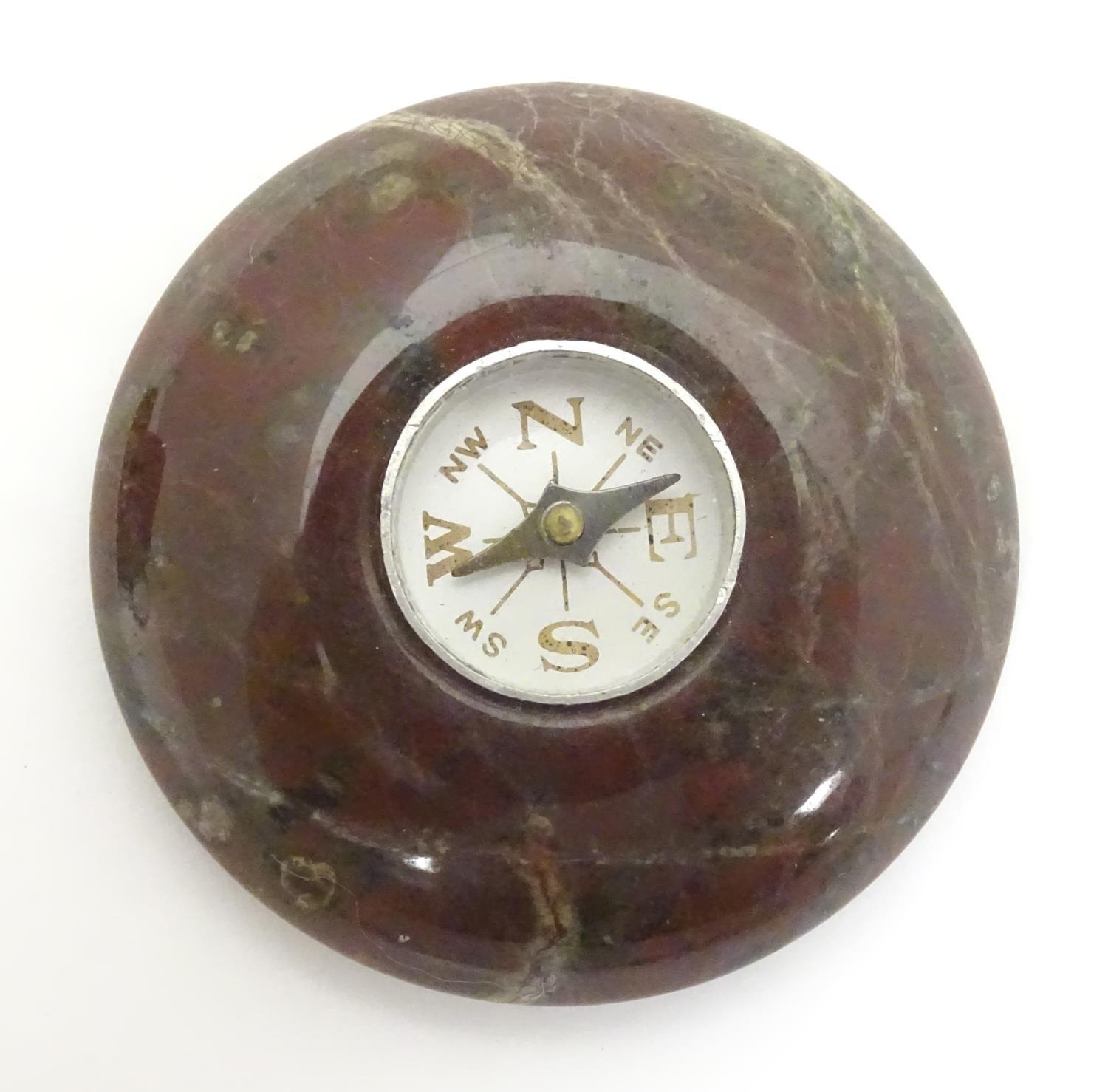 A pocket compass within an agate hardstone mount. Approx. 1 3/4" diameter Please Note - we do not