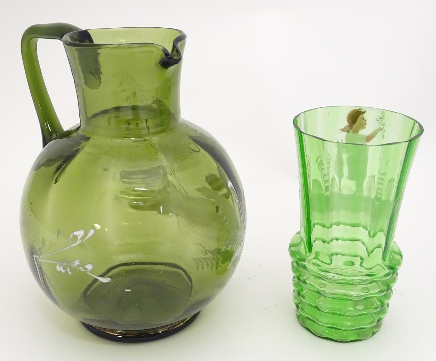 A Victorian olive green glass jug with Mary Gregory style decoration together with a green glass - Image 2 of 7