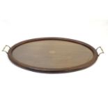 An Edwardian tray of oval form with parquetry inlay detail and twin handles. Approx. 17" x 31 1/2"