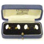 A set of four gold plated dress studs, boxed. Please Note - we do not make reference to the