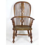 An early 19thC yew wood double bow back Windsor chair, having a pierced back splat flanked by shaped