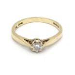 A 9ct gold ring set with diamond solitaire. The diamond approx 1/8" diameter. Ring size approx. L.