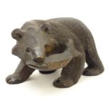 An Oriental carved wooden bear holding a fish. Incised marks to feet. Approx. 5 1/2" high Please