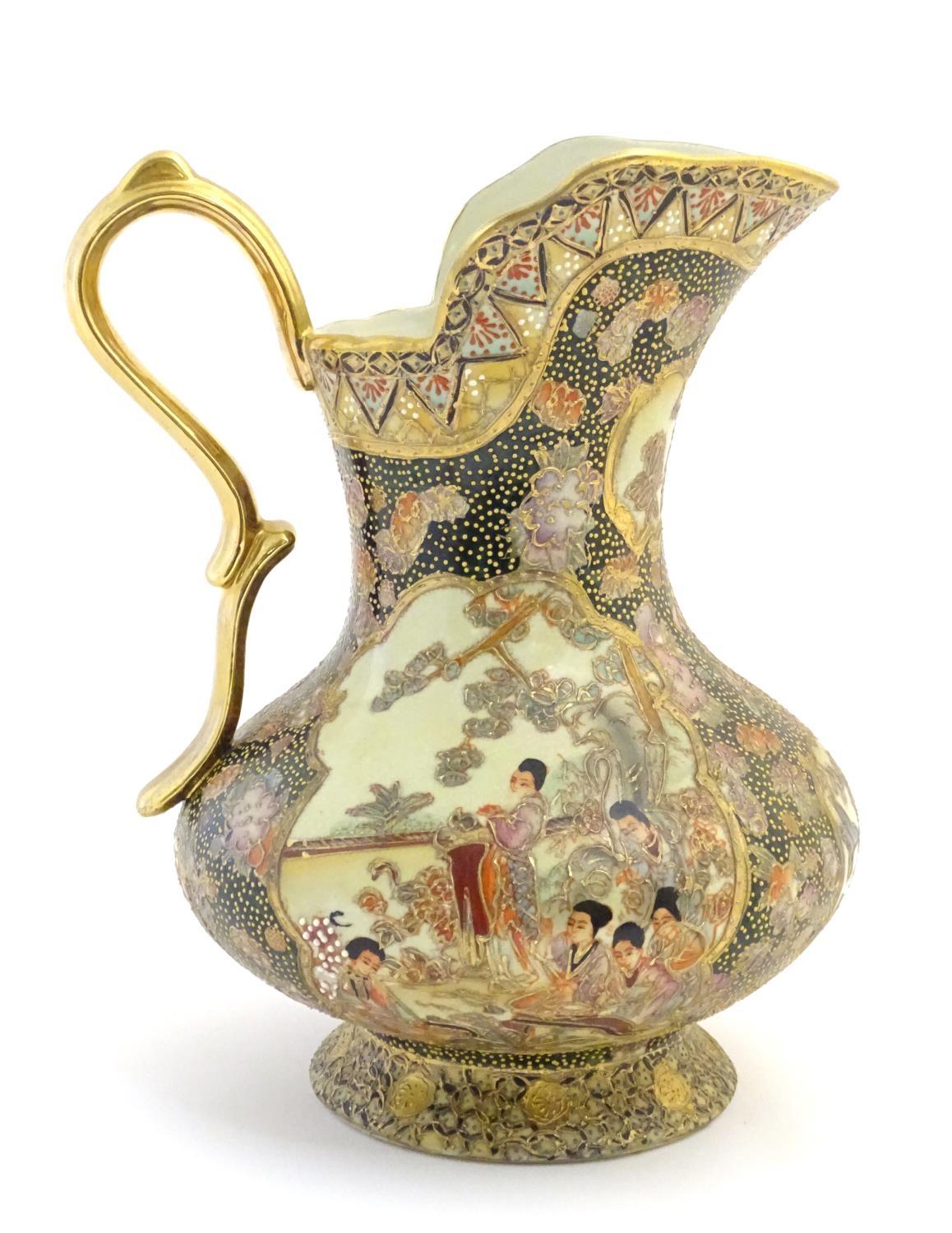 An Oriental jug / ewer with a bulbous body decorated with panels depicting ladies in a garden - Image 4 of 8