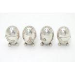 A set of 4 white metal pepperettes of egg form with Japanese menuki style cockerel / chicken