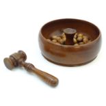 A turned wooden nut bowl with central section and gavel for nut cracking. Approx 9" wide overall