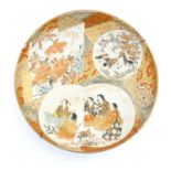 A Japanese satsuma charger with hand painted panelled decoration depicting stylised peony flowers, a