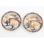A pair of Japanese plates / dishes with lobed rims in the Imari palette with hand painted decoration