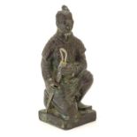 A 20thC model of a kneeling samurai. Approx. 5 1/4" high Please Note - we do not make reference to