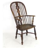 A mid 19thC ash and elm high back Windsor chair with a bowed back above a central pierced splat