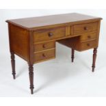 A 19thC mahogany desk with a moulded top above two long over four short drawers with turned wooden