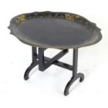 A Victorian tray top table of papier mache construction with a shaped painted tray above an