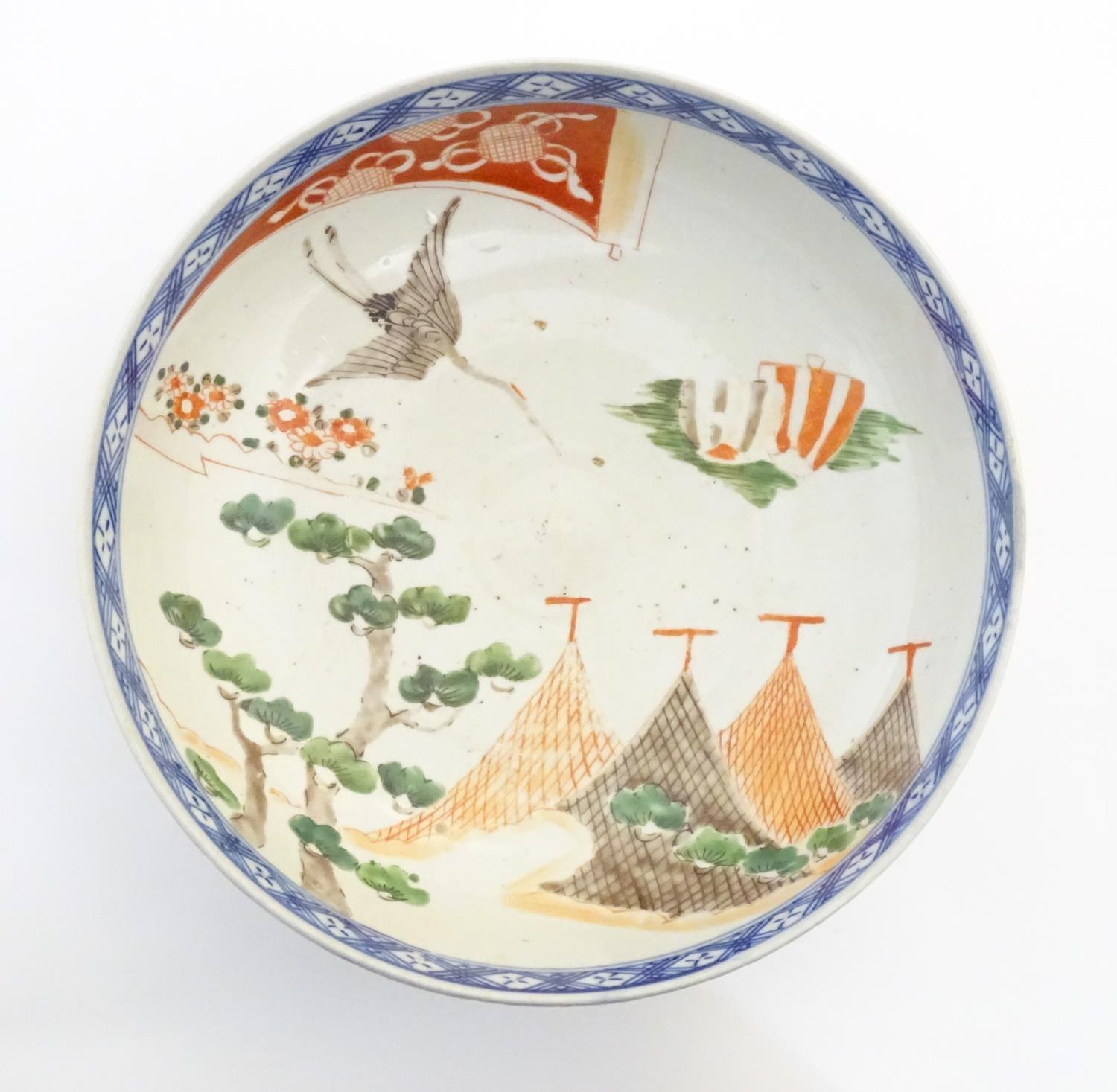 A Japanese bowl with hand painted decoration depicting a landscape scene with flowers, a crane - Image 6 of 7