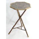 An occasional table / jardinière stand with bamboo frame and octagonal top with embossed inset