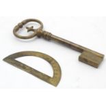 A late 19thC large brass presentation key. Together with a brass protractor. Key approx. 7" (2)