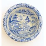 A 19thC blue and white small strainer, decorated with an Oriental landscape scene with pagodas