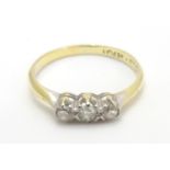 An 18ct gold ring set with trio of diamonds. Ring size approx M Please Note - we do not make