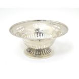 A silver bonbon dish with beaded edge and pierced decoration raised on circular foot. Hallmarked