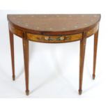 A late 18thC satinwood demi lune card table with floral painted decoration to the top, frieze and