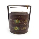 A Chinese lacquered food storage container / carrier of cylindrical form with two tiers and a bamboo