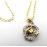 A 9ct gold pendant formed as a horseshoe with horsehead detail set with diamonds, on a 9ct gold