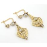 A pair of gold drop earrings set with diamonds and pearls. Approx 1 1/2" long Please Note - we do