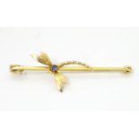 A 9ct gold bar brooch with dragon fly detail set with sapphire to body 2 3/4" long Please Note -