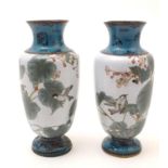 A pair of Oriental enamel cloisonne vases decorated with flowers, foliage and birds, the neck