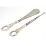 A silver handled shoe horn and a silver handled lace / button hook. Both hallmarked Birmingham