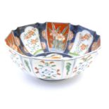 A Japanese octagonal bowl in the Imari palette the centre decorated with ducks in a pond, the
