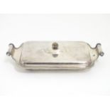 A silver plate entree dish with outwept handles. 13" wide overall Please Note - we do not make