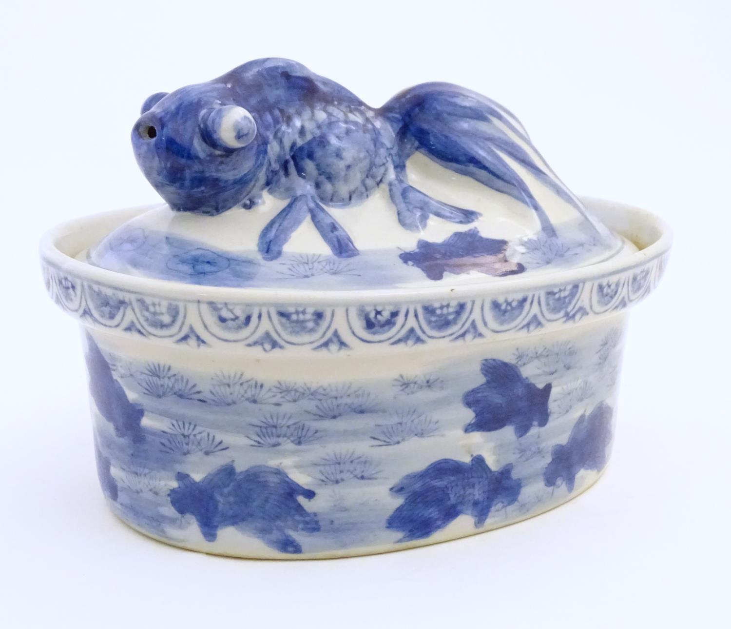 A Chinese blue and white dish and cover of oval form, the lid surmounted by a fish in relief, the - Image 3 of 6