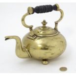 A late 19thC brass kettle of squat form with squat bun feet. Approx 7 1/2" high Please Note - we