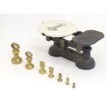 Victorian cast iron scales with 7 brass weights and a ceramic plate depicting the figure of