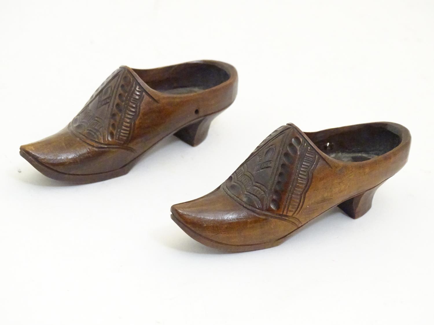 A pair of 20thC carved miniature clogs. Approx. 3 3/4" long (2) Please Note - we do not make