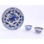 A Chinese blue and white plate decorated with auspicious artifacts such as scrolls, vases and