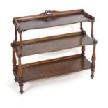 A 19thC continental mahogany buffet with a foliate carved upstand above fluted supports and carved