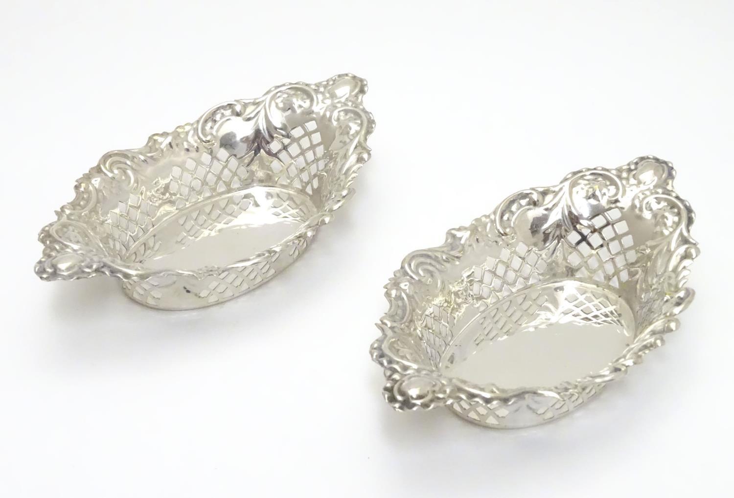 A pair of silver plate bon bon dishes with pierced decoration. Approx. 6" long (2) Please Note -