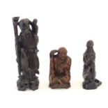 Three 20thC carved figures comprising an Oriental elder with a staff, child and crane; a Buddha