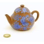 A Chinese Yixing clay teapot with blue flower and butterfly decoration. Incised character marks