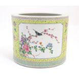 A Chinese famille jaune planter with a floral and foliate ground and panelled decoration with