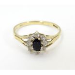 A 9ct gold sapphire floral cluster ring bordered by white stones. Ring size approx N 1/2 Please Note